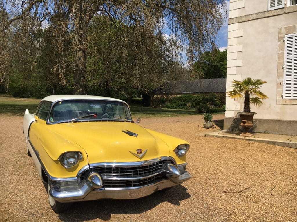 Vintage American car in front of the Château de Chanteloup, a 5-star campsite in the Sarthe near Le Mans